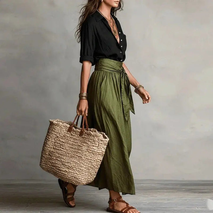 Women's elegant linen co-ord set, ideal for summer, featuring a button-up top and a stylish midi skirt.