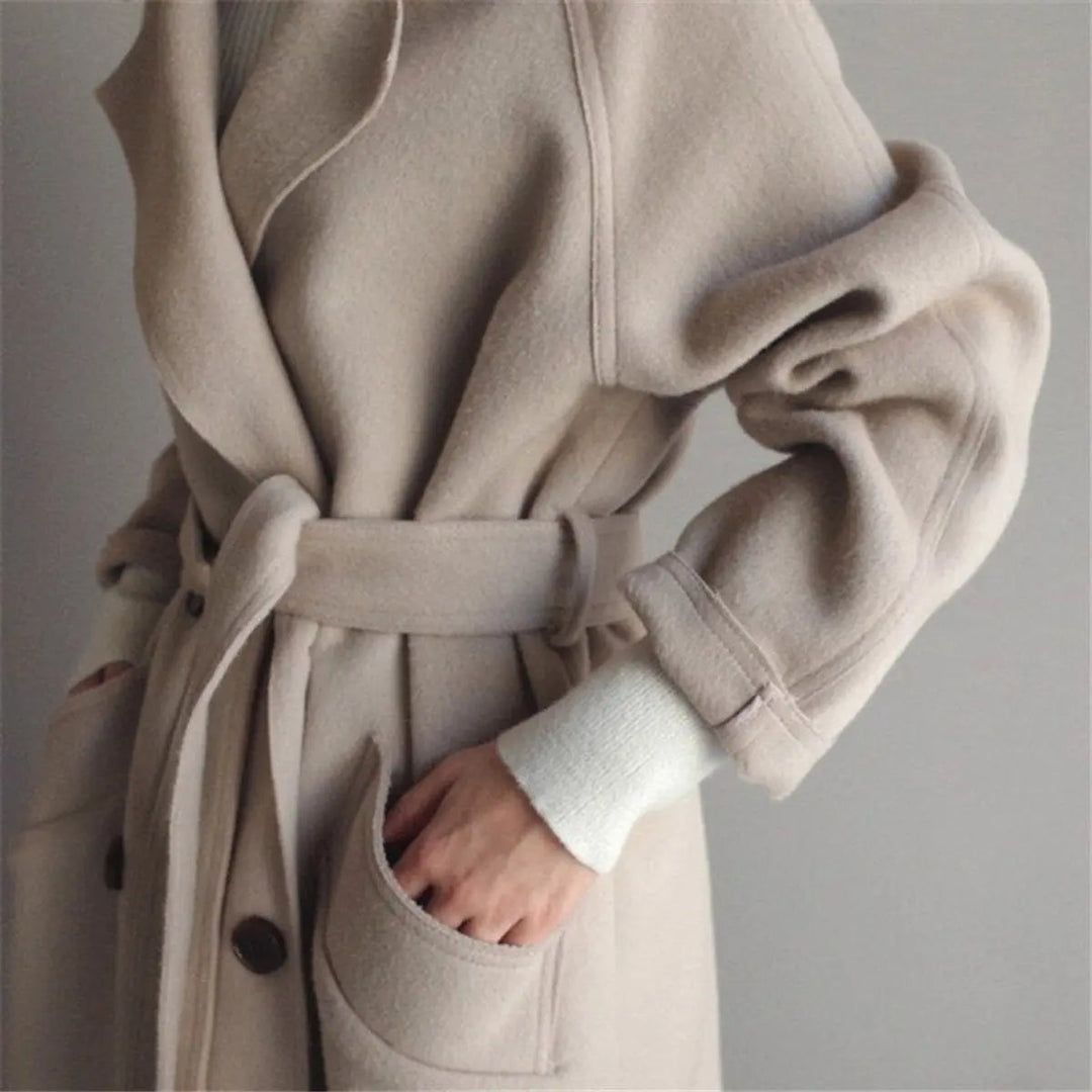 Stylish women's long cashmere overcoat. Double-breasted design for elegant winter warmth in cold weather.
