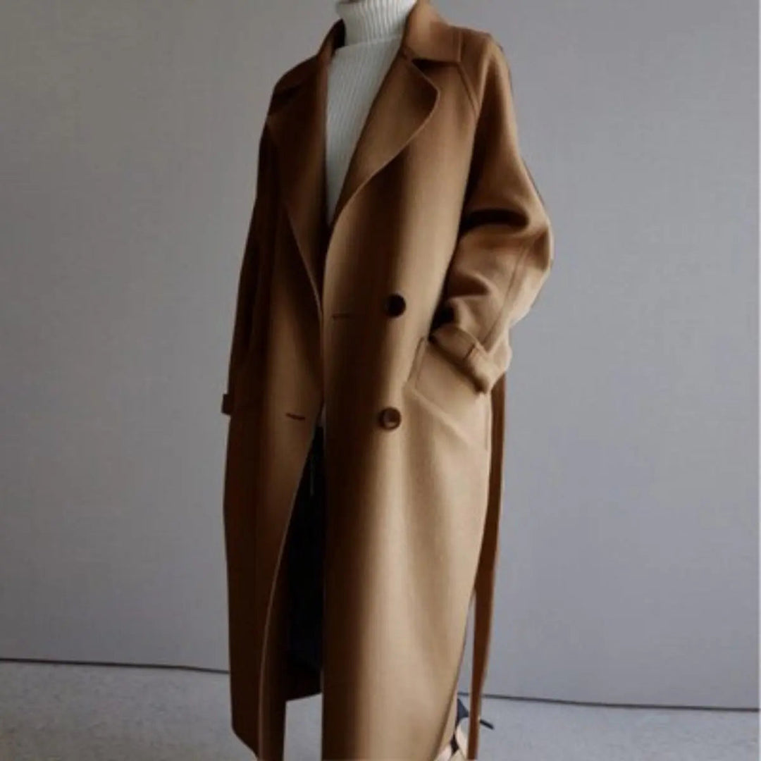 Woman wearing elegant long double-breasted cashmere overcoat. Perfect tailored outerwear for winter fashion.
