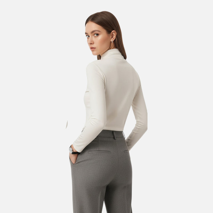 Sophisticated women's blouse featuring a unique criss-cross neckline and long sleeves.