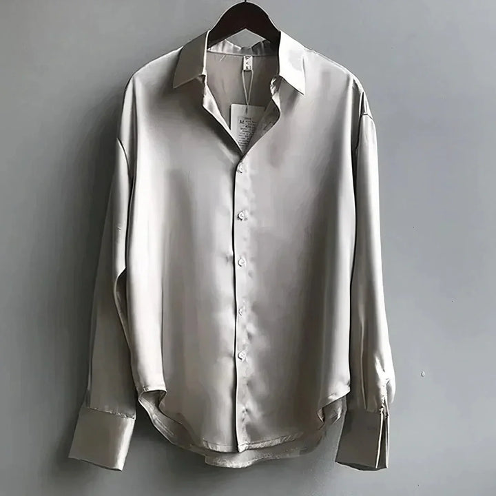 Fashionable women's elegant blouse featuring long sleeves & a classic button-down design.