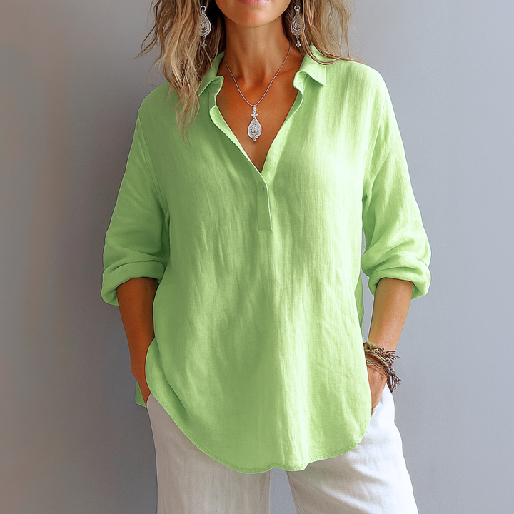 White long sleeve women's blouse with elegant collar & partial button placket. Ideal for versatile business casual fashion.