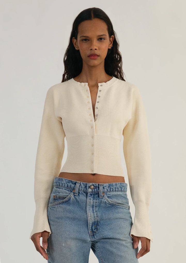 Chic women's cropped cardigan with long sleeves and functional button-up front.