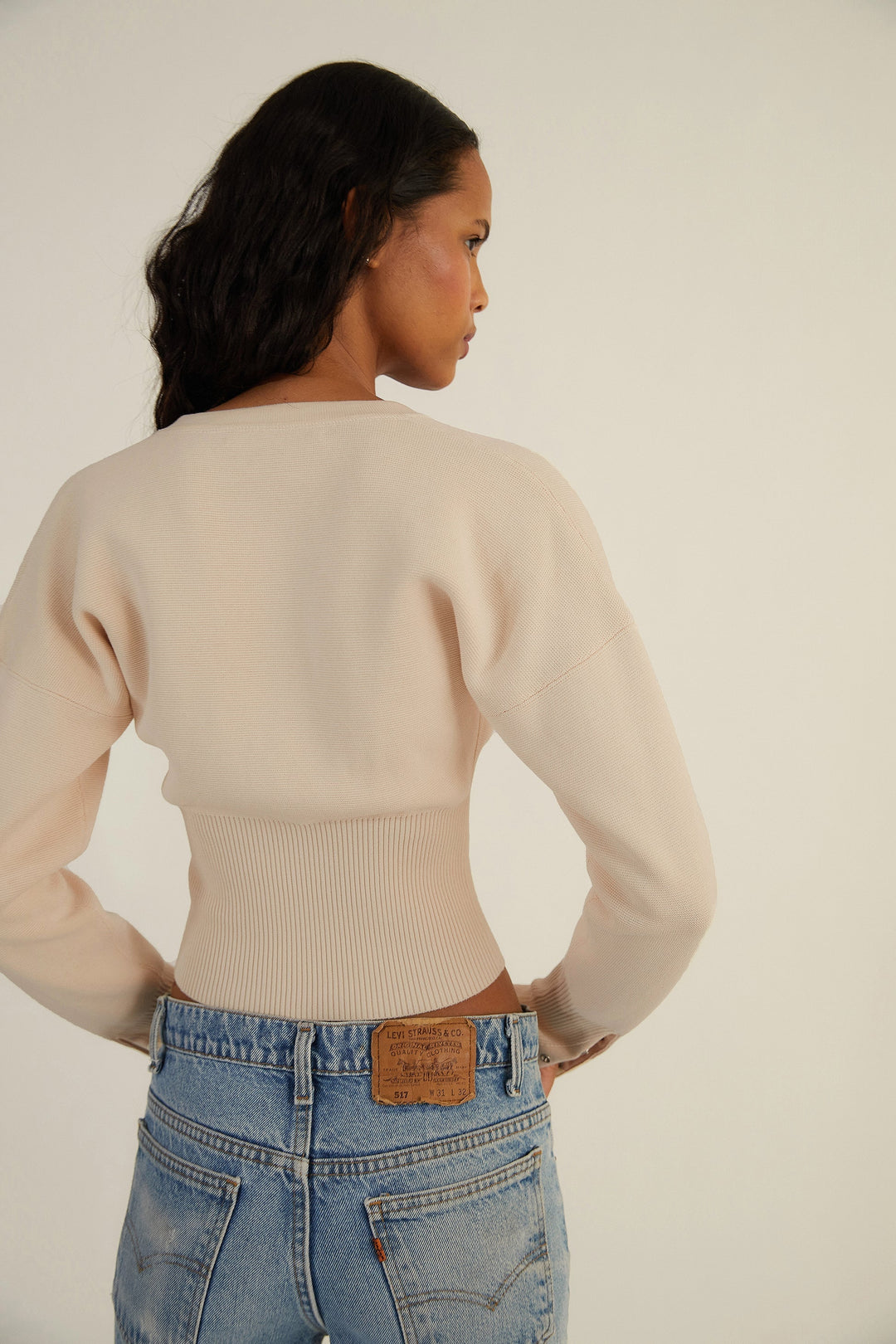 Stylish women's knitwear: a long sleeve cropped button-up cardigan top.