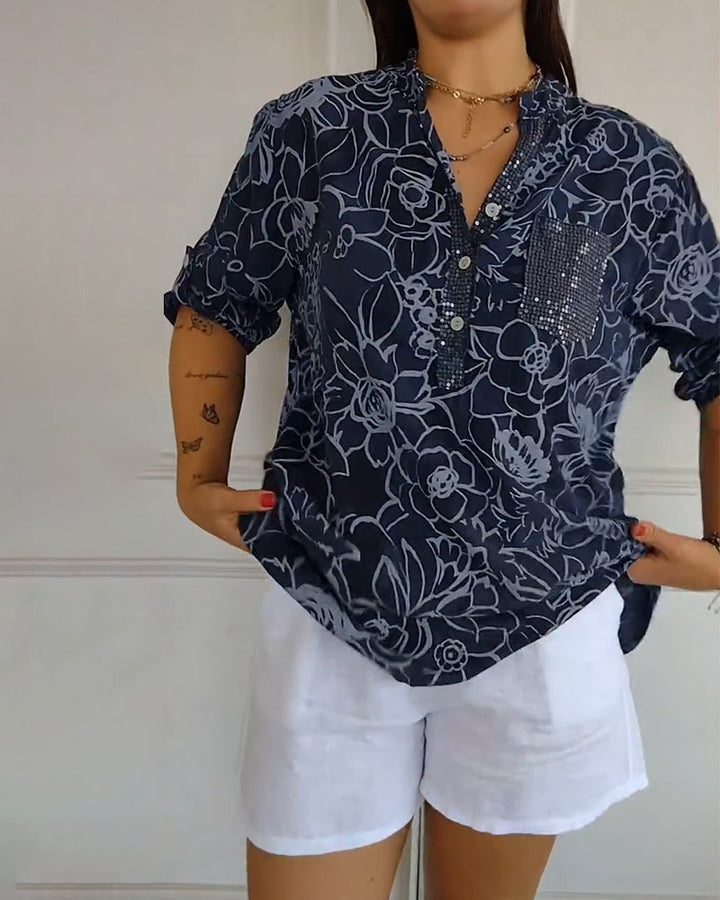 Close-up: Sophisticated floral pattern on elegant women's long sleeve blouse. Versatile top detail.
