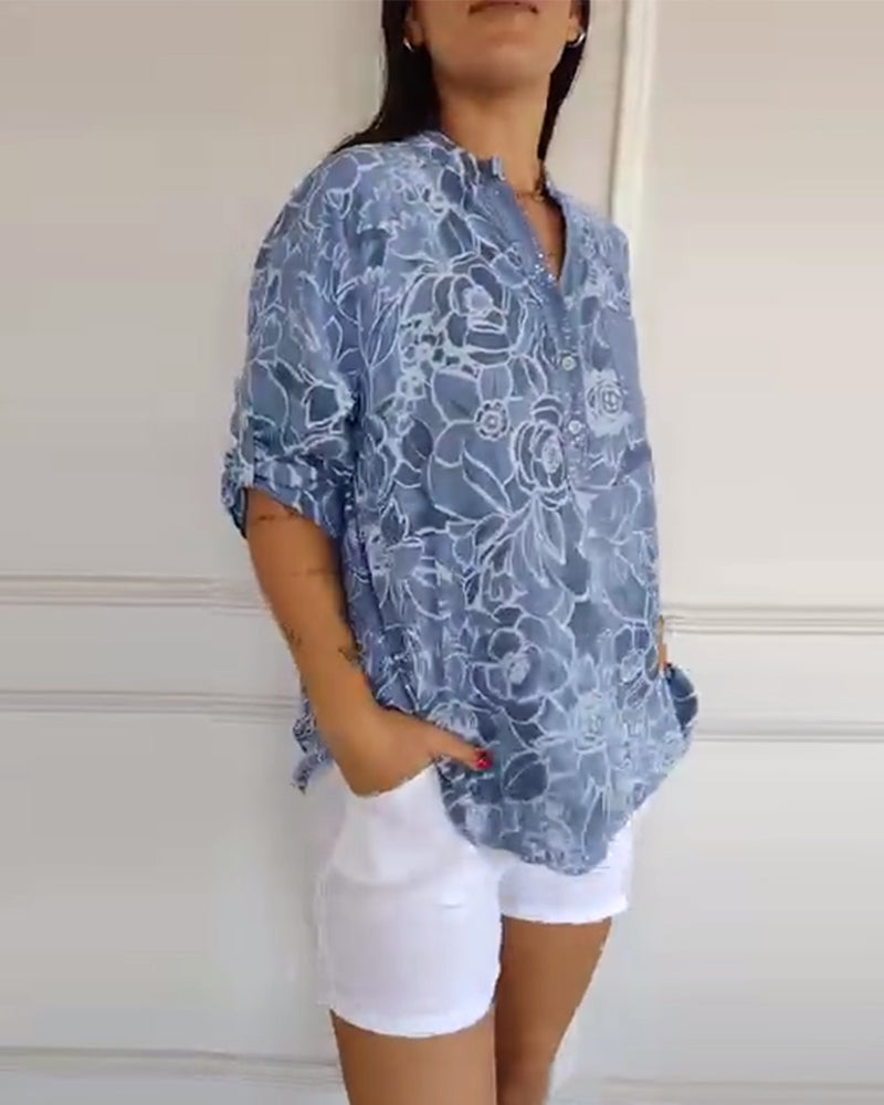 Back view of women's sophisticated floral blouse. Elegant long sleeve top, versatile spring style.