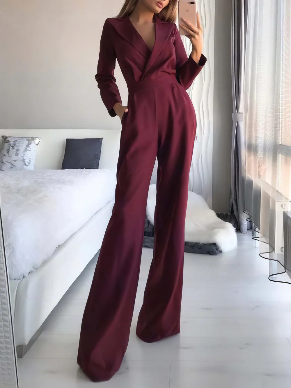 Wine red sophisticated women's jumpsuit featuring long sleeves, wide legs, and a flattering V-neck design.