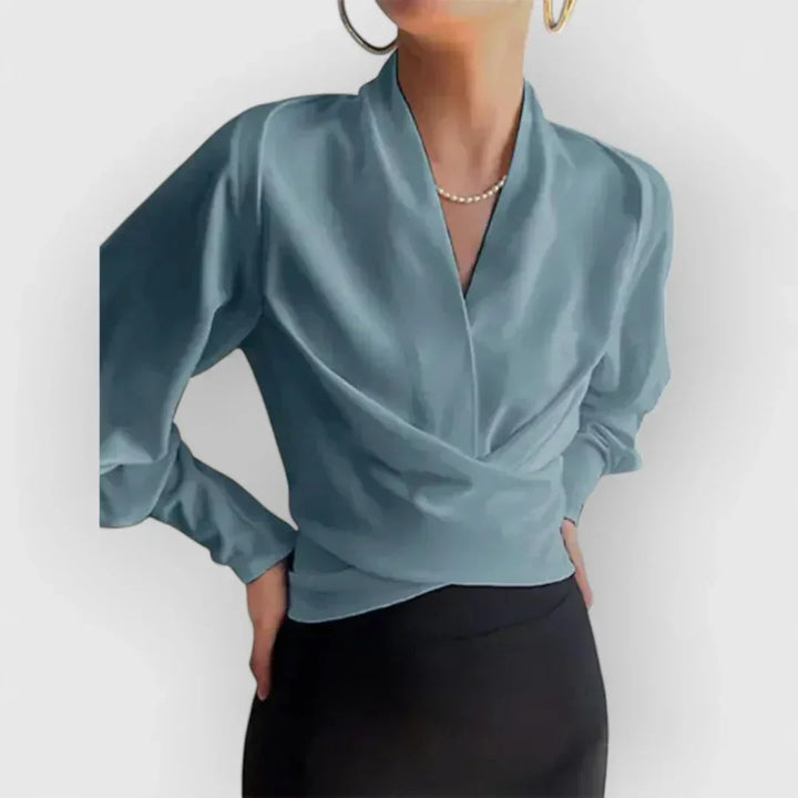 Stylish women's wrap blouse, perfect for office elegance or casual comfort. Long sleeve versatile top.