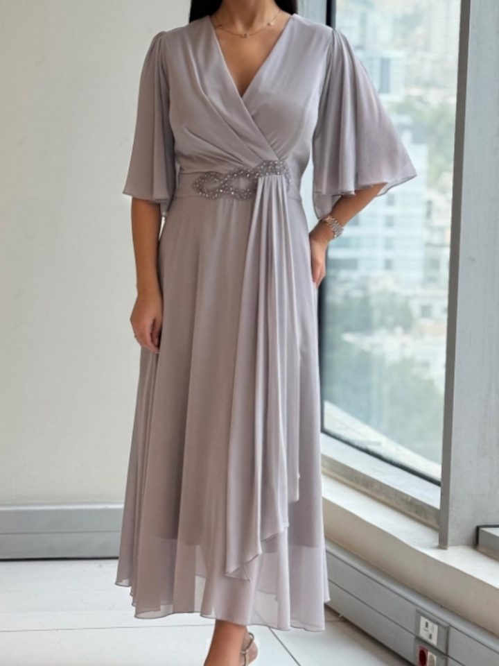 Elegant women's long V-neck maxi dress, perfect for formal evening events or special occasions. Flowing design.