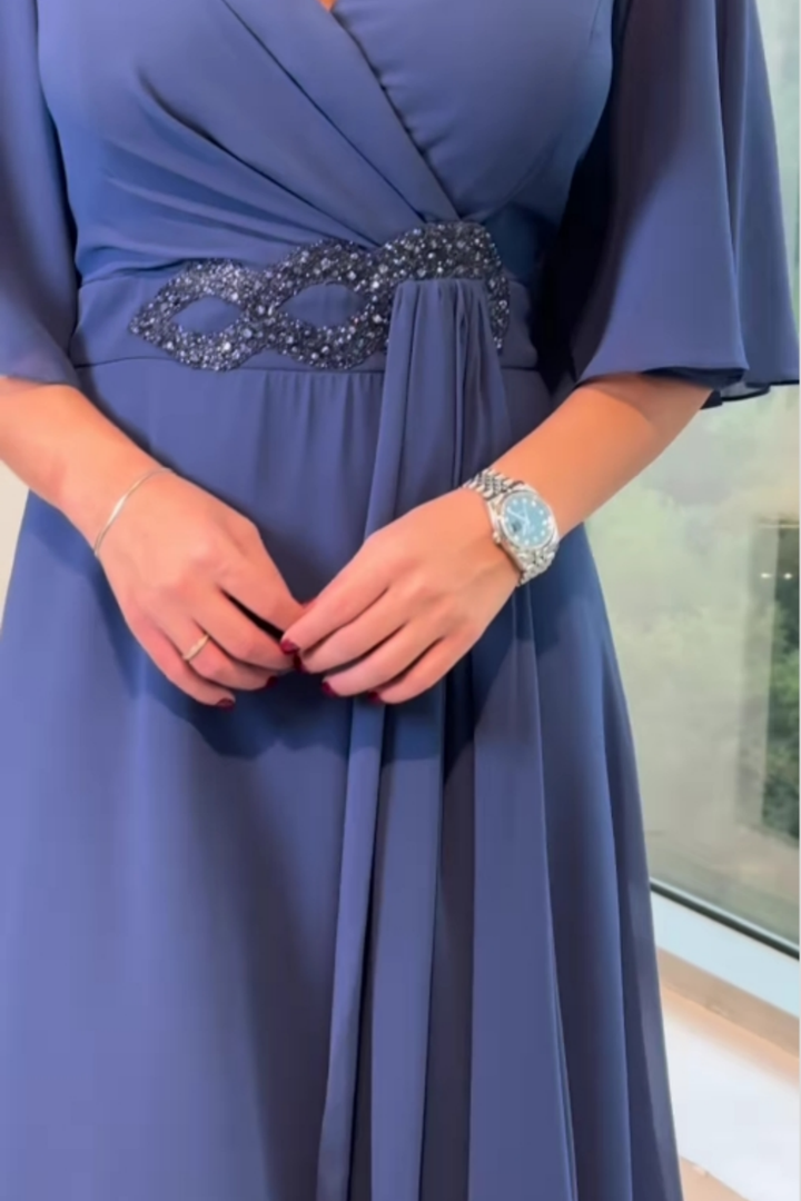 Women's elegant V-neck occasion dress. Long, flowing, perfect for formal events, evening parties, or special gatherings.