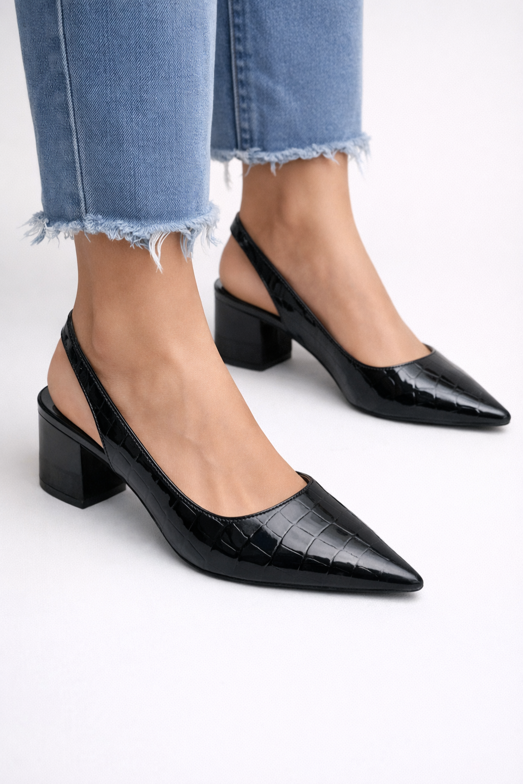 Stylish brown women's slingback pumps featuring a comfortable low block heel and elegant pointed toe.