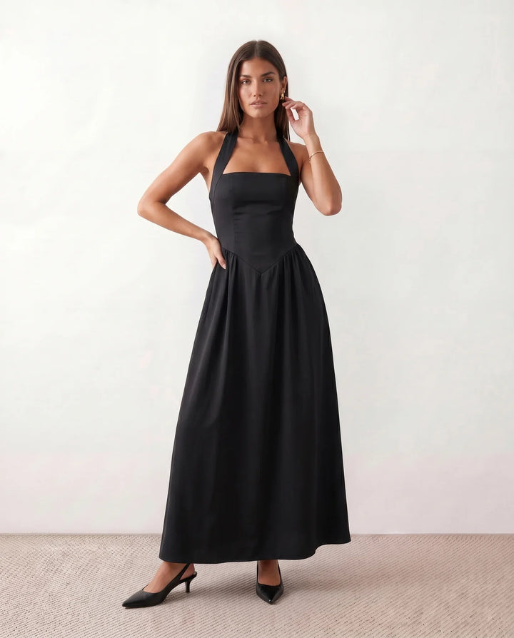 Fashionable women's sleeveless maxi dress with an elegant halter neck, versatile for summer casual or evening wear.