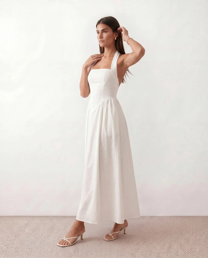 Flowy women's summer maxi dress featuring an elegant halter neck, perfect for a breezy and stylish warm-weather outfit.