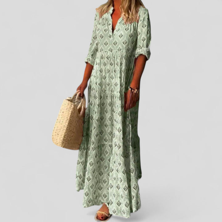 Stylish long women's maxi dress featuring comfortable roll-up sleeves & beautiful ethnic print for spring & summer.