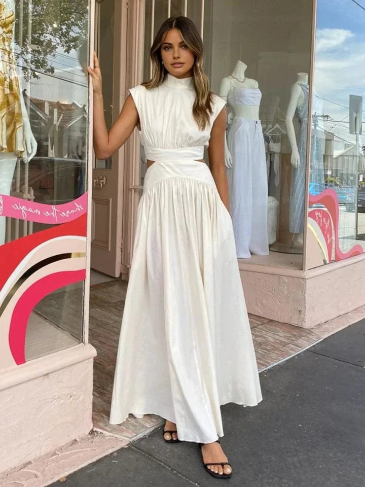 Sophisticated sleeveless maxi dress with a chic stand collar & stylish waist cut-out. Ideal for evening events.