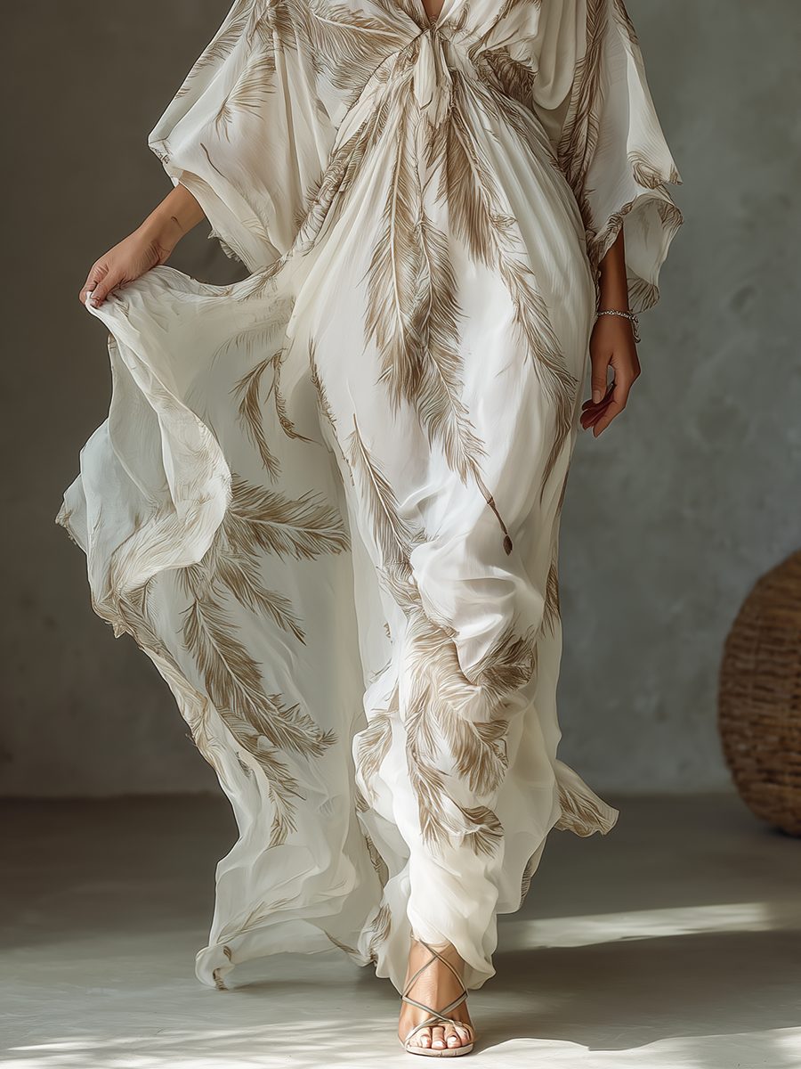 Feather print women's maxi dress with a chic twist front and comfortable dolman sleeves. Perfect for elegant summer events.