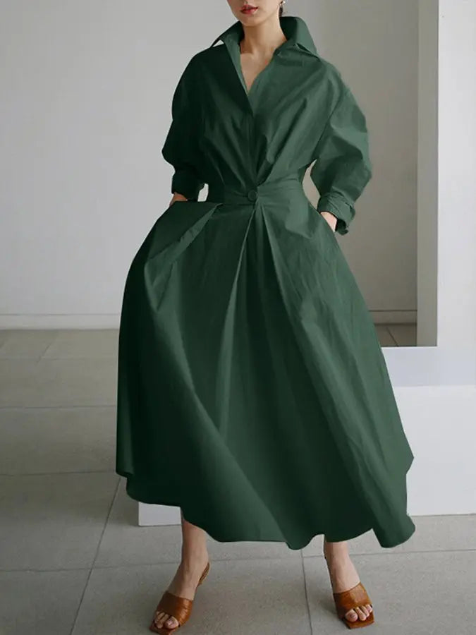 Fashionable women's maxi shirt dress featuring long sleeves, a flattering wrap belt, and elegant design.