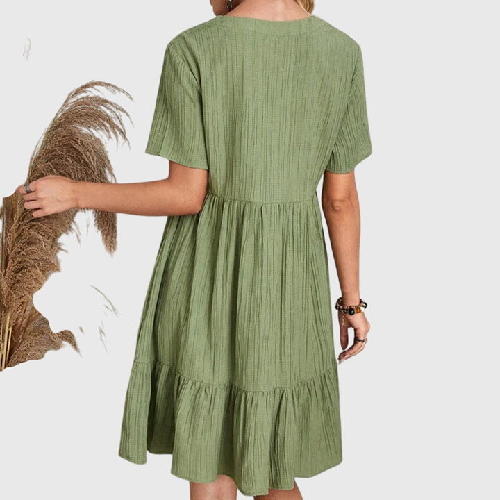 Woman in elegant flattering midi dress, perfect for special occasions. Chic party & sophisticated summer style.