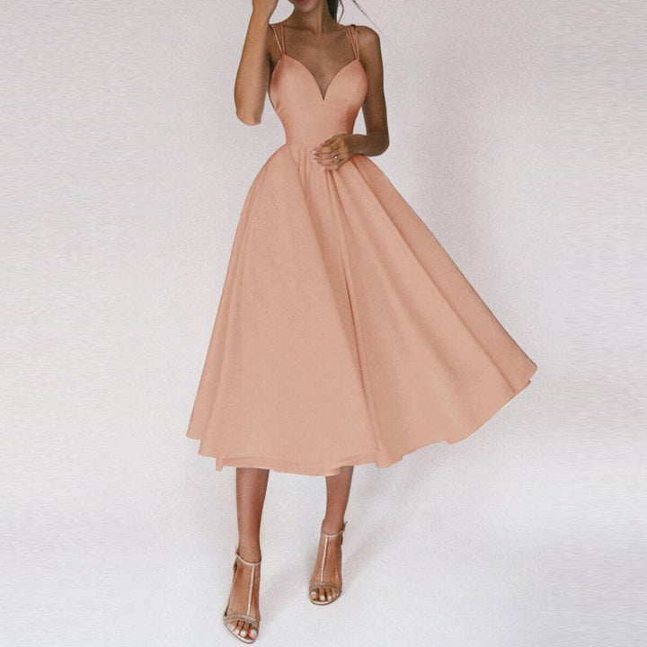 Stylish women's evening dress with a flared skirt and eye-catching strap detailing.