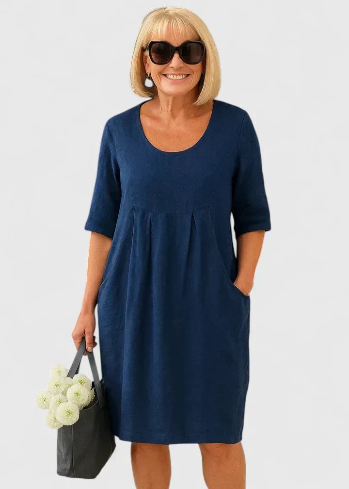 Chic women's casual dress with half sleeves & convenient pockets. Elegant scoop neck midi length for comfort.