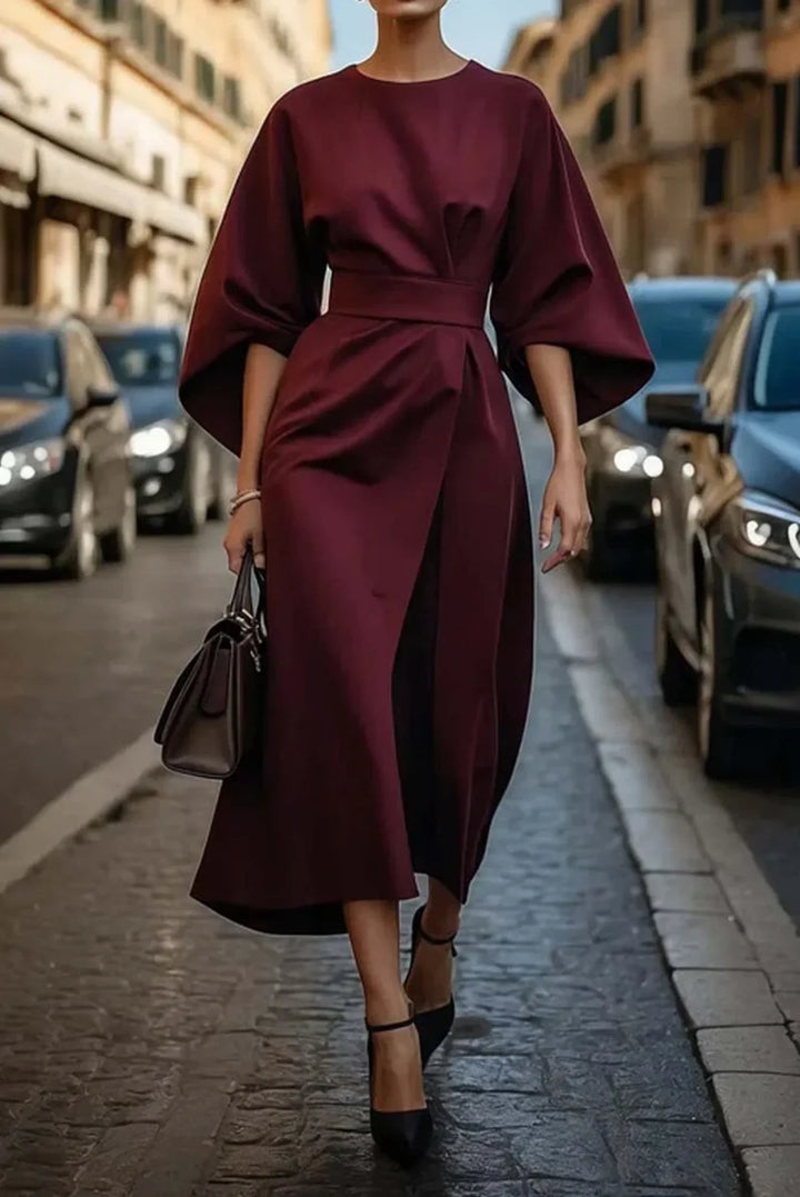 Elegant plus size women's midi dress. Features lantern sleeves, a tie-waist, and a flattering wrap front.