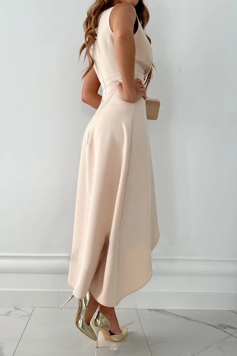 Stylish women's midi wrap dress, featuring V-neck, sleeveless design, and asymmetric hem. Great for formal wear.