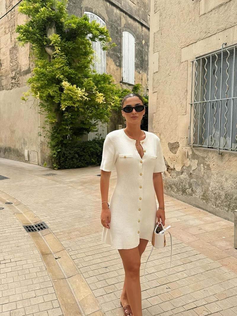 Elegant women's mini dress with chic gold button detail, perfect for day to night style.