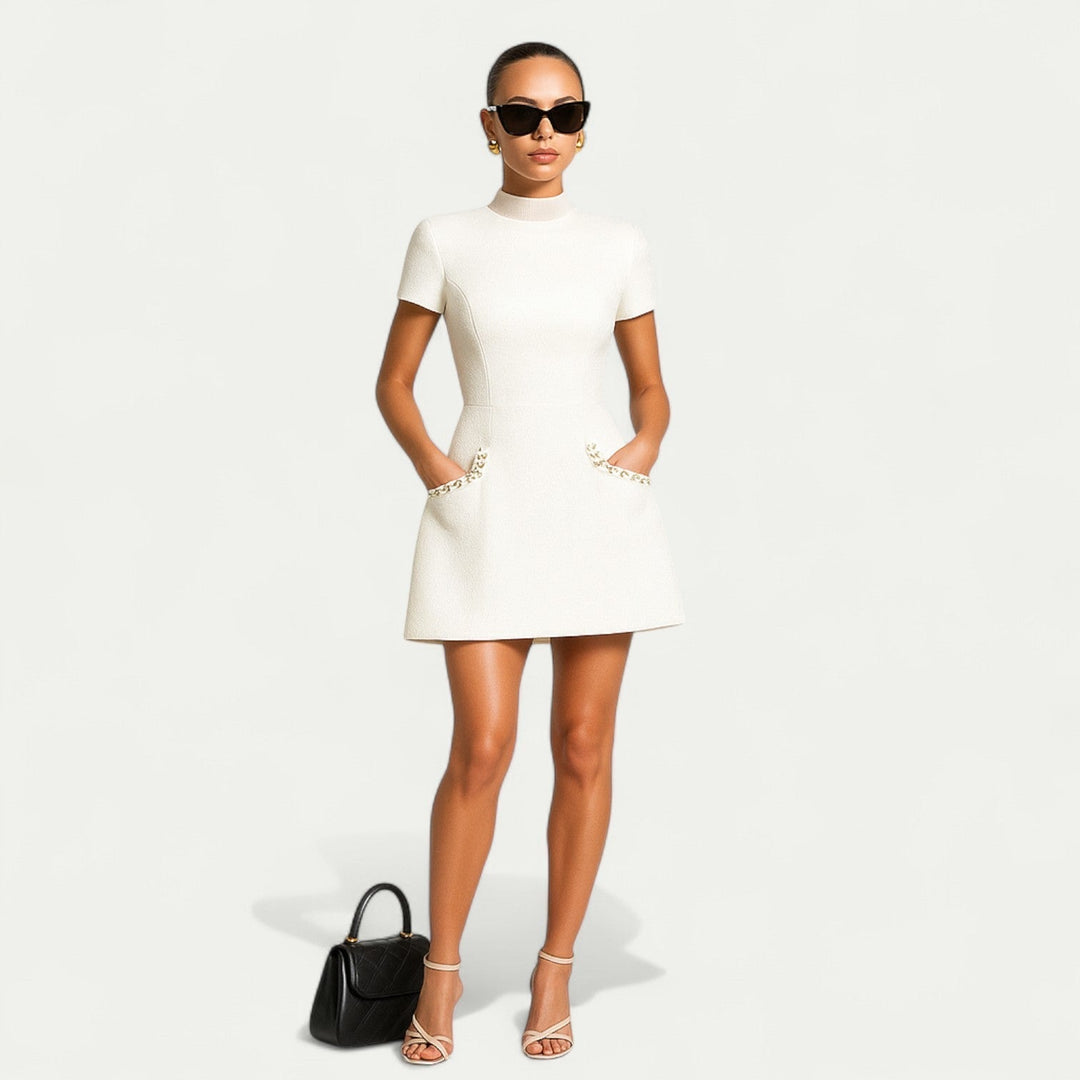 Modern women's mini dress with exquisite pearl trim & pocket detail. A comfortable short sleeve dress for versatile styling.