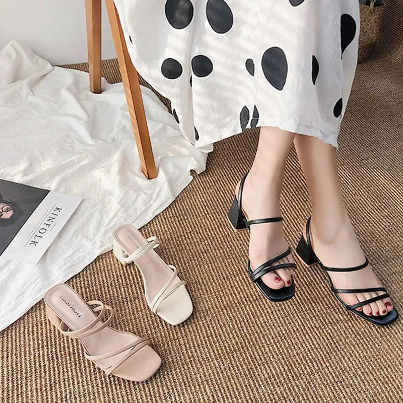 Close-up of women's dress sandals: intricate multi-strap design, sturdy block heel, and sleek square toe.
