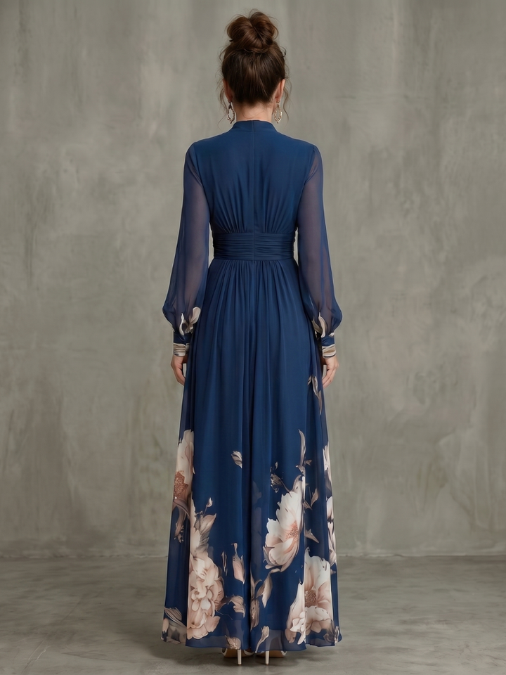 Close-up of the delicate sheer sleeve detail on a sophisticated navy pleated women's maxi dress.
