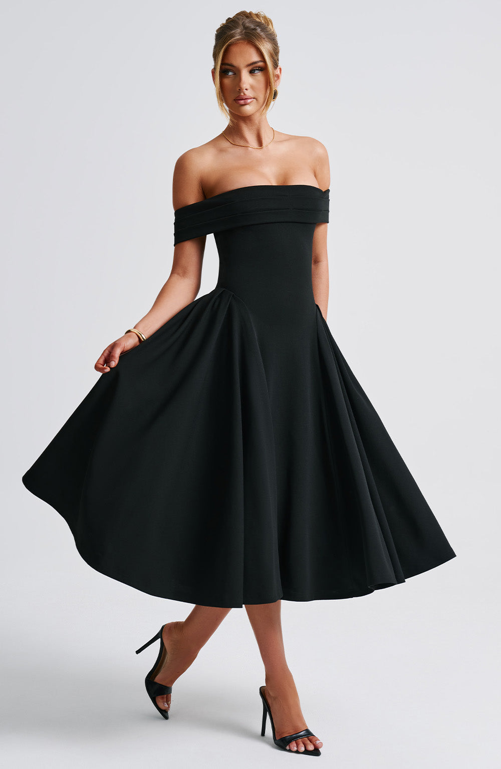 Elegant women's A-line midi dress with off-shoulder design, flattering for formal occasions.