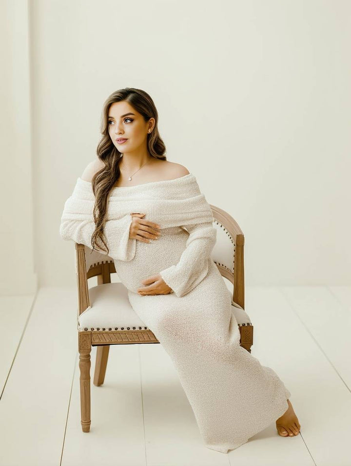 Graceful women's maternity dress with off-shoulder neckline & long sleeves for pregnant comfort.