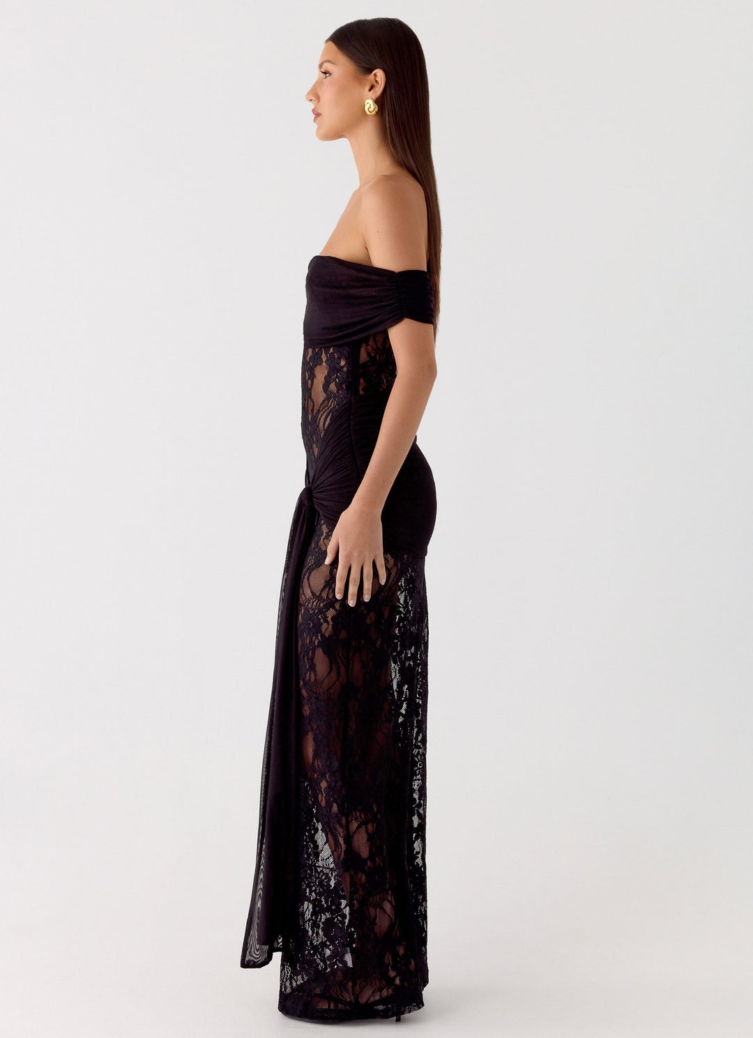 Close-up of intricate lace detail on an elegant women's off-shoulder maxi dress, perfect for formal events.
