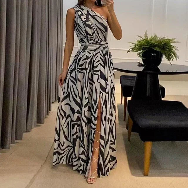 Flowing women's one-shoulder long dress featuring a bold zebra print, ideal for special occasions.