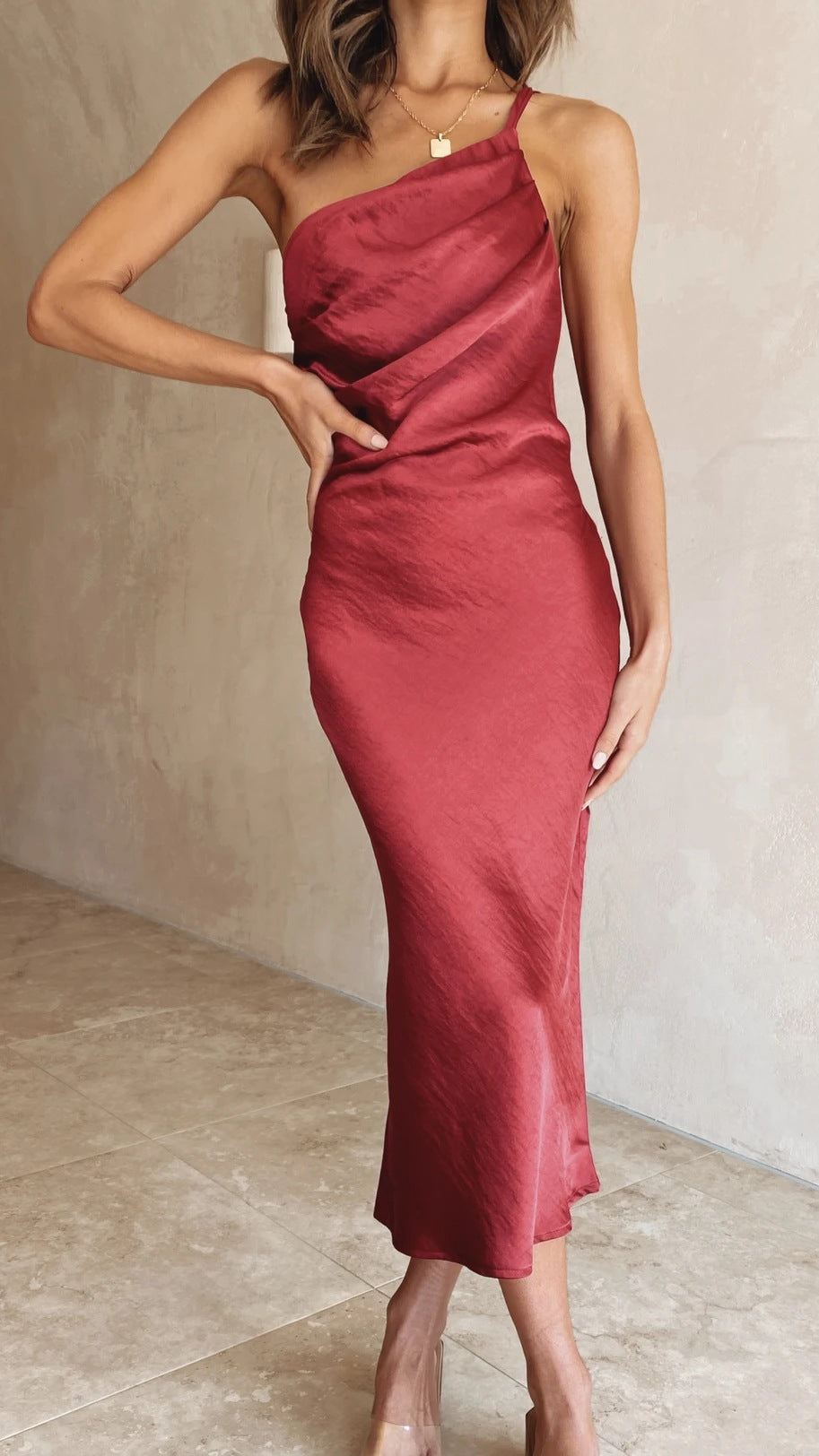 Asymmetrical one-shoulder women's midi dress, a sophisticated option for wedding guest attire.