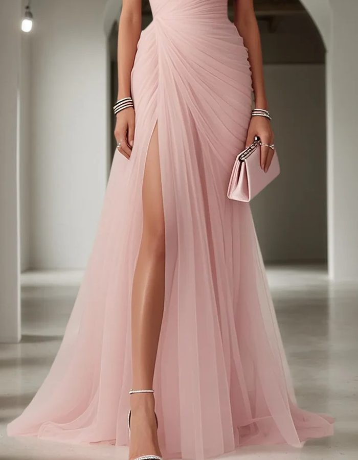 Chic one-shoulder long dress with delicate pleats, suitable as a formal wedding guest outfit.