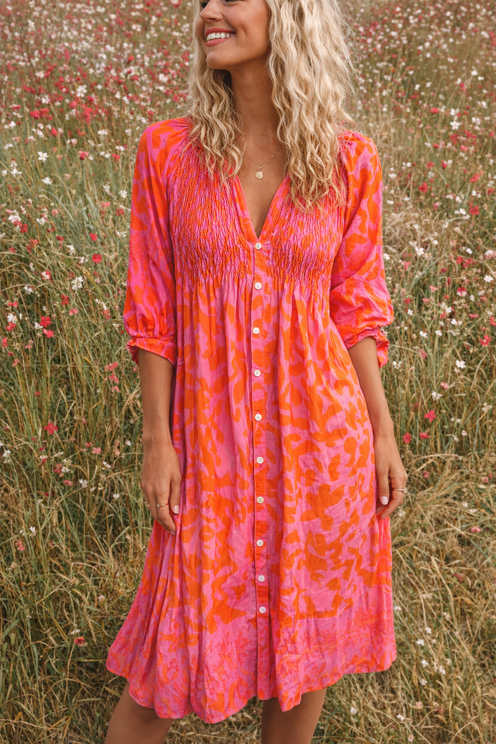 Elegant women's orange midi dress, flowy fabric, perfect for summer fashion or spring party wear.