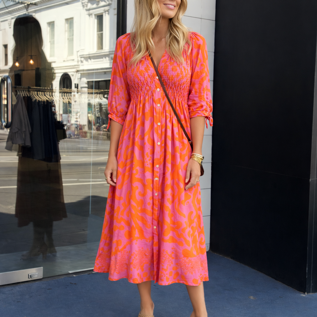 Feminine orange midi dress for women, elegant and flowy, ideal for special occasions or party wear.