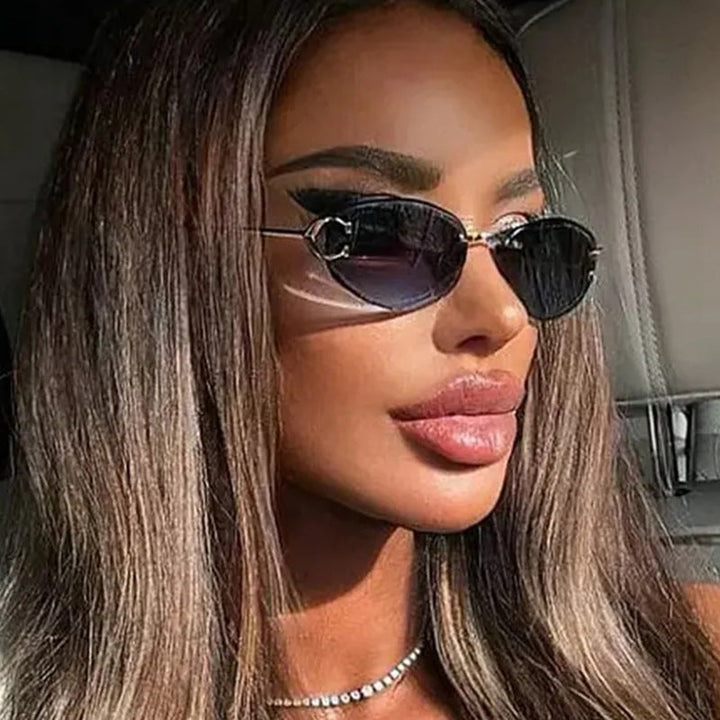 Elegant women's oval sunglasses with a chic frame, perfect for fashion-forward looks. UV protected summer accessory.