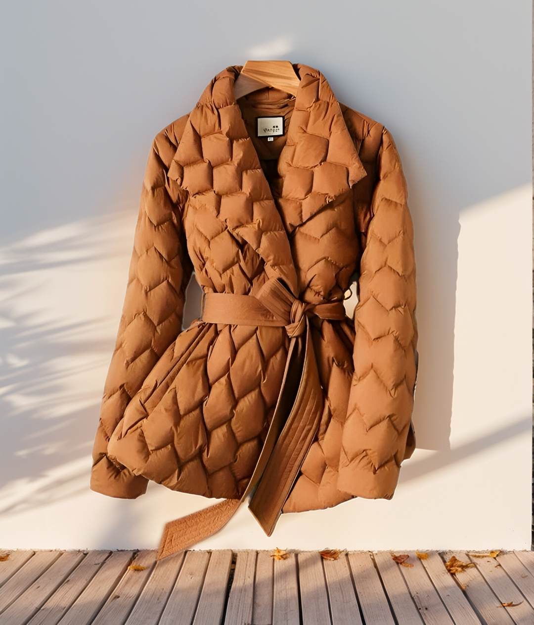 Elegant women's padded jacket in caramel. Stylish, warm winter outerwear with a flattering belted waist.