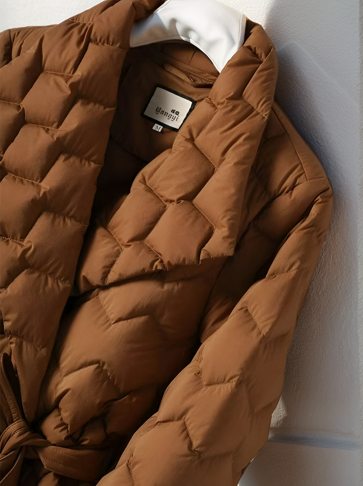 Warm Sophie padded jacket for women, featuring a chic belted waist. Elegant and comfortable fall/winter outerwear.