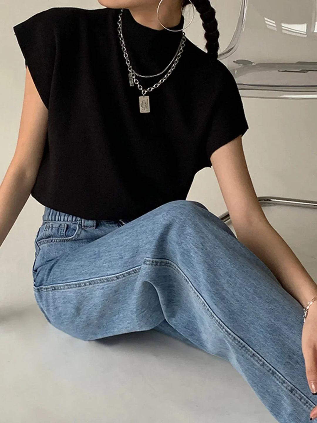 Women's fashionable mock-neck top, designed with padded shoulders and stylish cap sleeves.