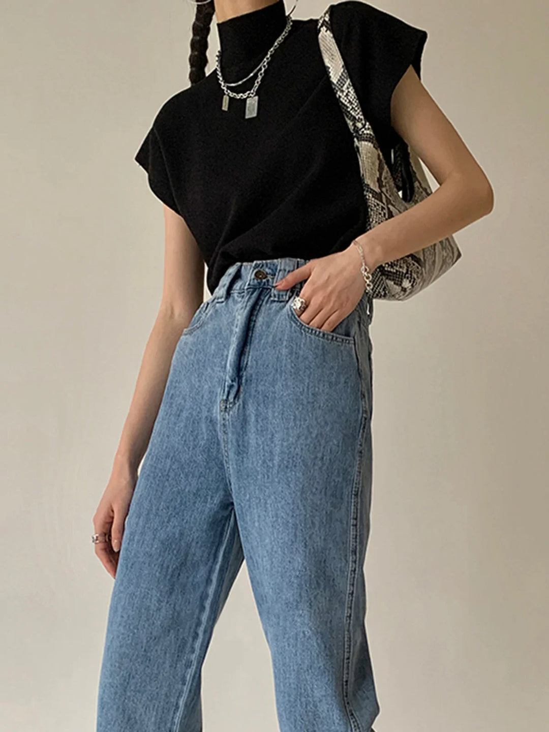 Elegant women's smart casual top: mock neck, cap sleeves, and structured padded shoulders.