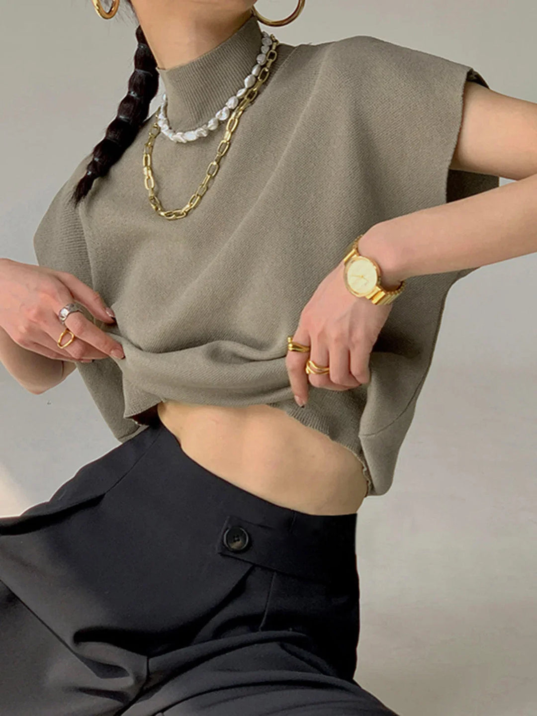 Structured women's cap sleeve top with a chic mock neck and comfortable padded shoulders.