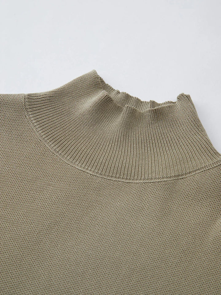Elegant women's cap sleeve top, featuring a mock neck and structured padded shoulders.