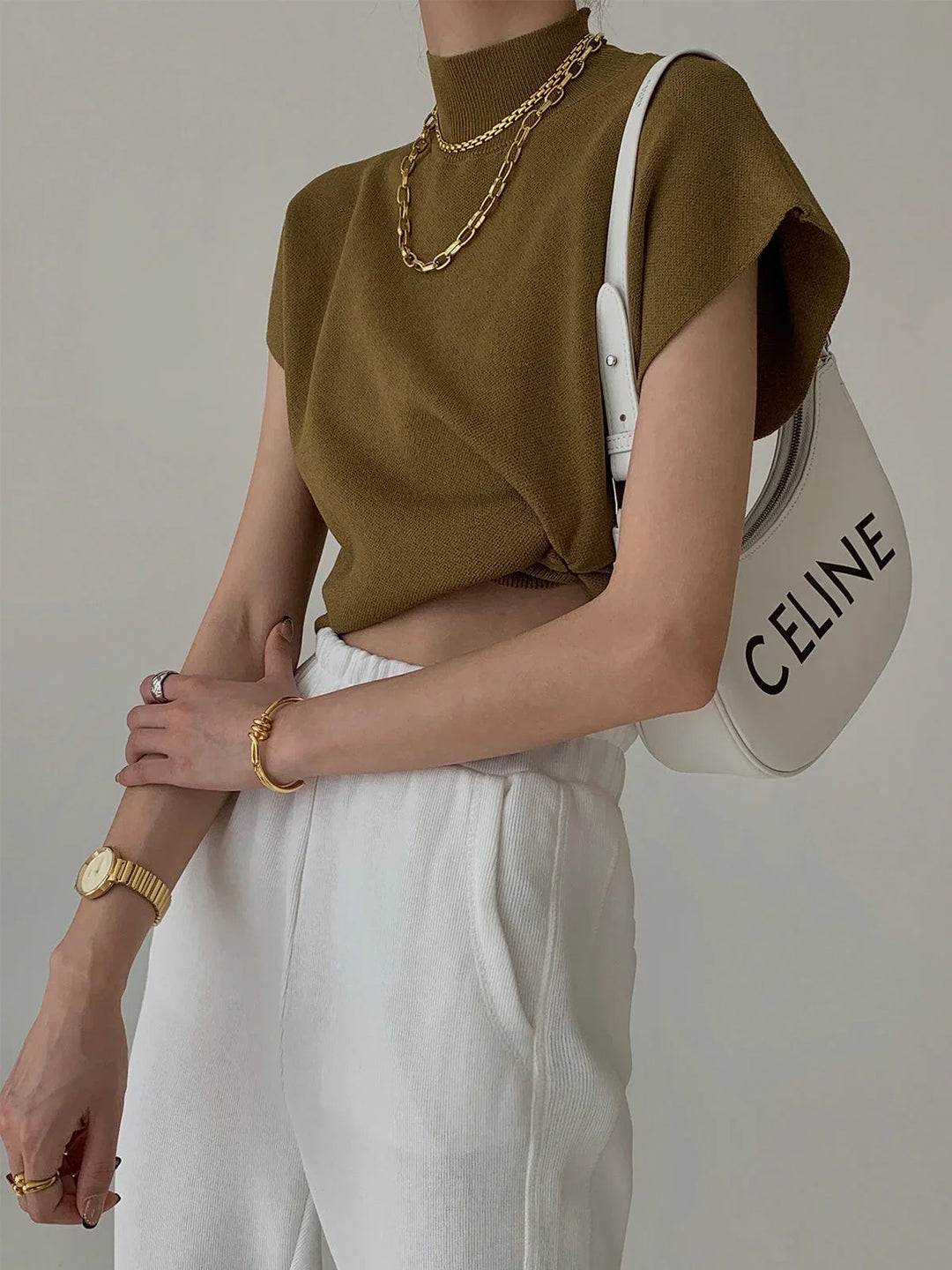 Versatile women's sweater: solid color, mock neck, padded shoulders, and stylish cap sleeves.