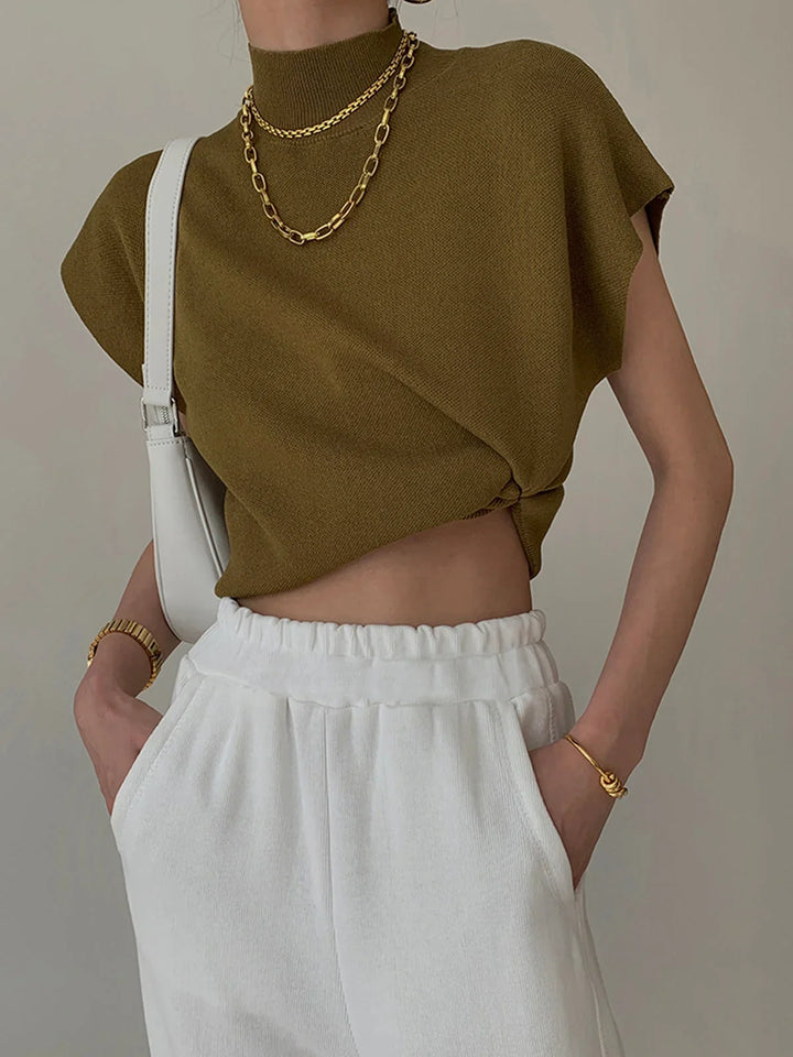 Versatile solid color padded-shoulder top for women, featuring a sophisticated mock neck & cap sleeves.