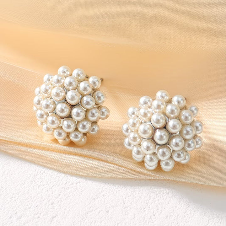 Close-up of a single elegant pearl dome stud earring, showcasing the lustrous pearl & sleek design for women.