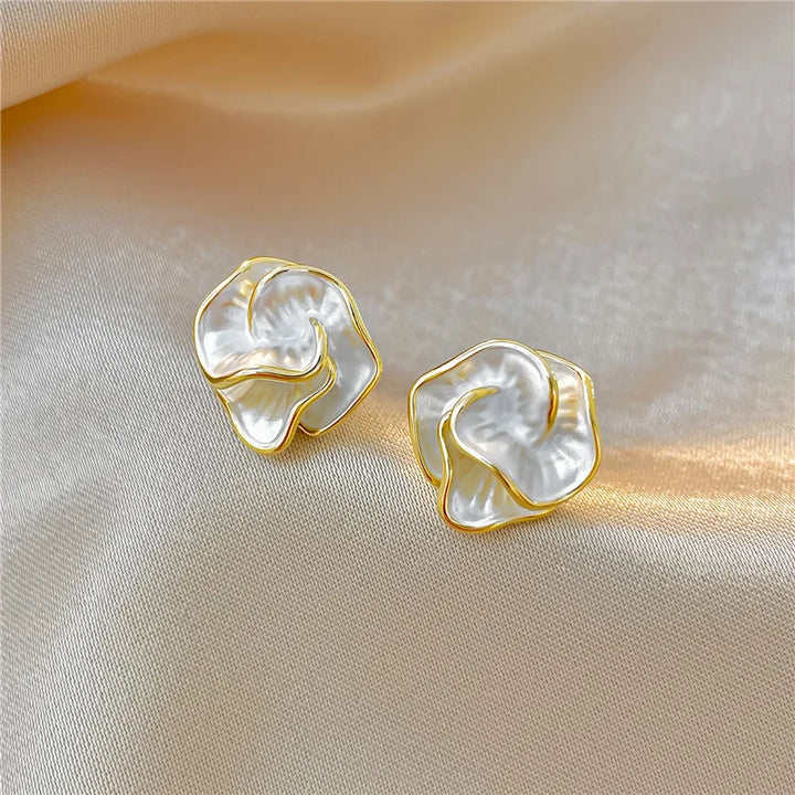 Detailed view of women's elegant pearl flower stud earrings, a timeless and charming accessory.