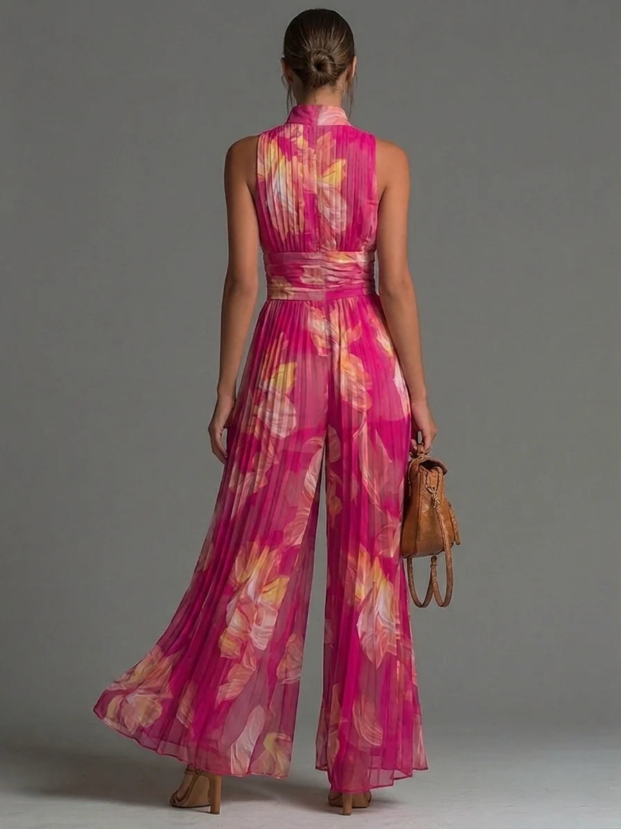 Flowing sleeveless women's floral halter jumpsuit with wide pleated legs, ideal for elegant evening events.